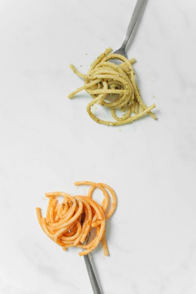 two different types of pasta on forks